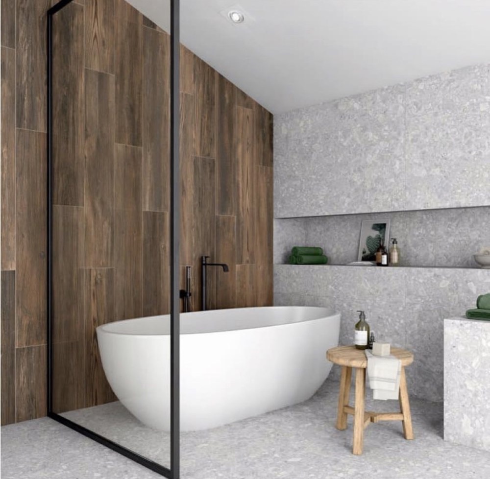 Modern freestanding bathtub and finished bathroom tile work